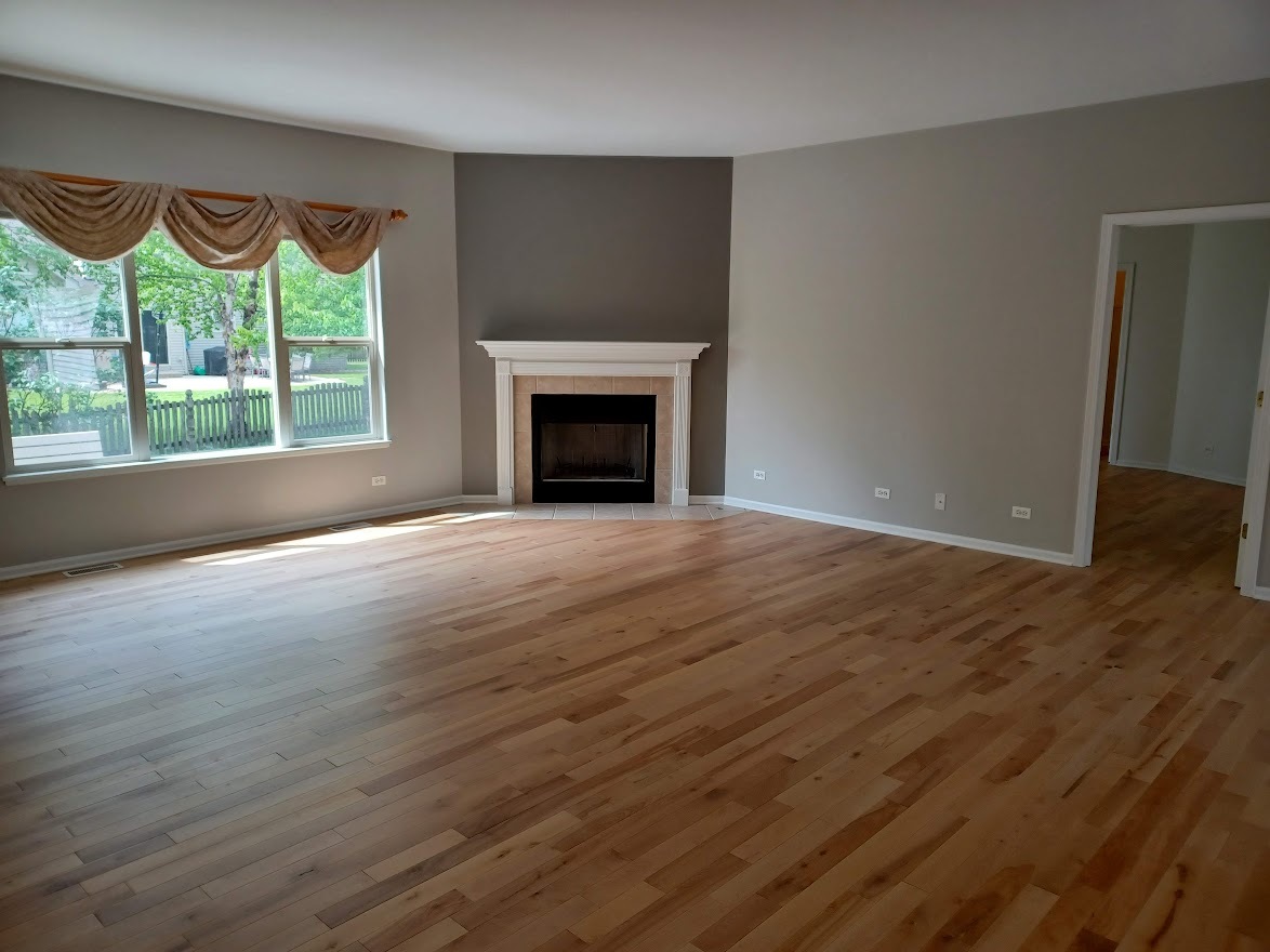 24463 Tufton Street Plainfield, IL 60585 - Photo 4 of 29 a view of an empty room with a window and wooden floor