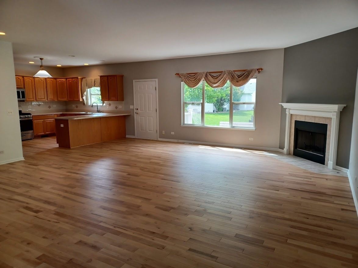 24463 Tufton Street Plainfield, IL 60585 - Photo 5 of 29 a view of kitchen with kitchen island wooden floor and window