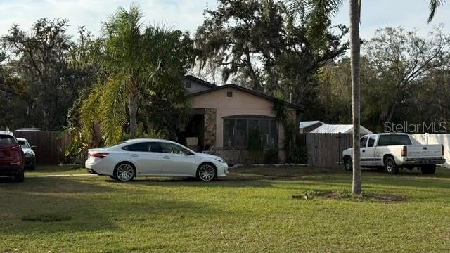 a white house covered with tall trees
