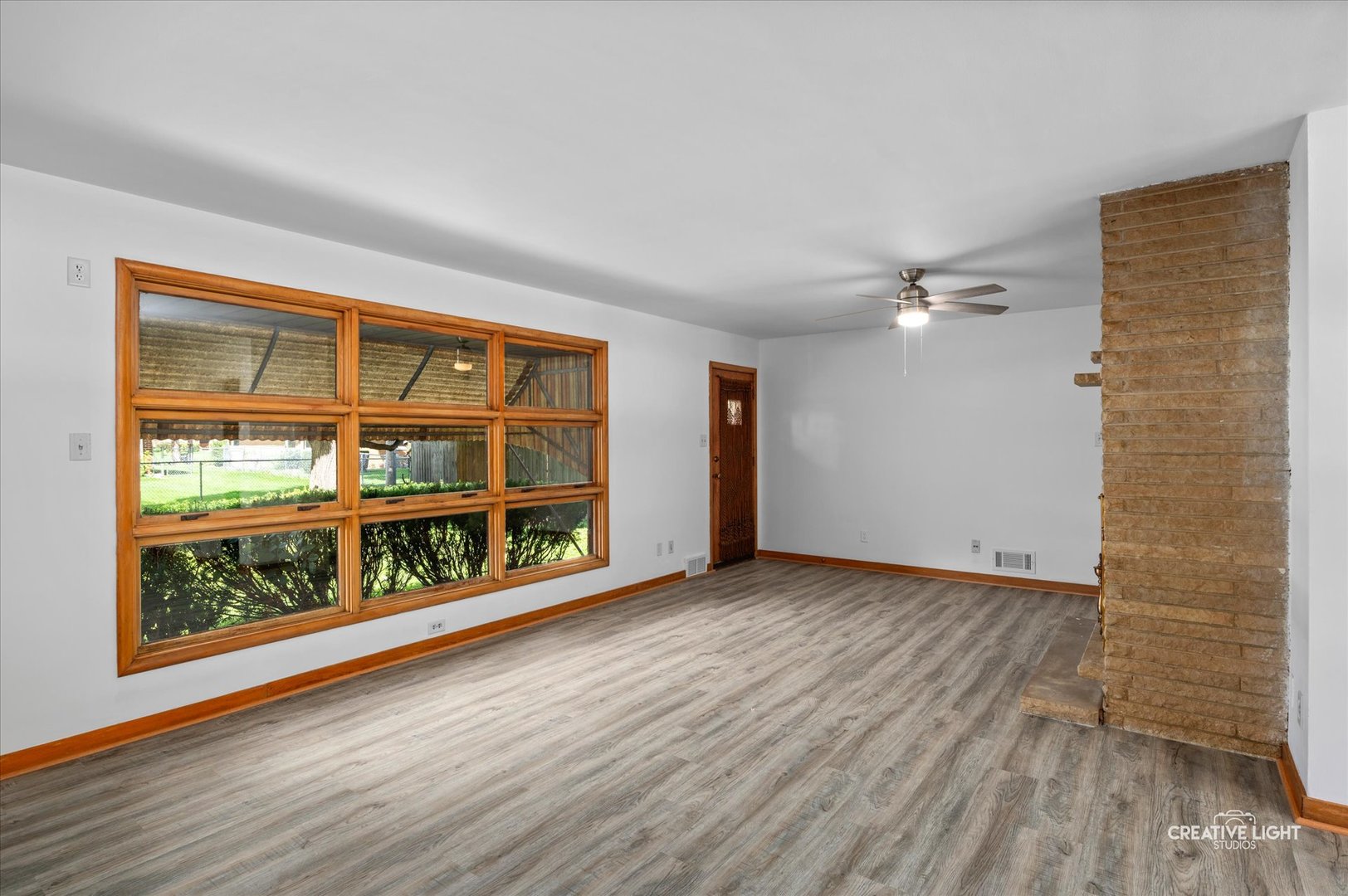 803 Alann Drive Joliet, IL 60435 - Photo 6 of 15 a view of an empty room with wooden floor and a window