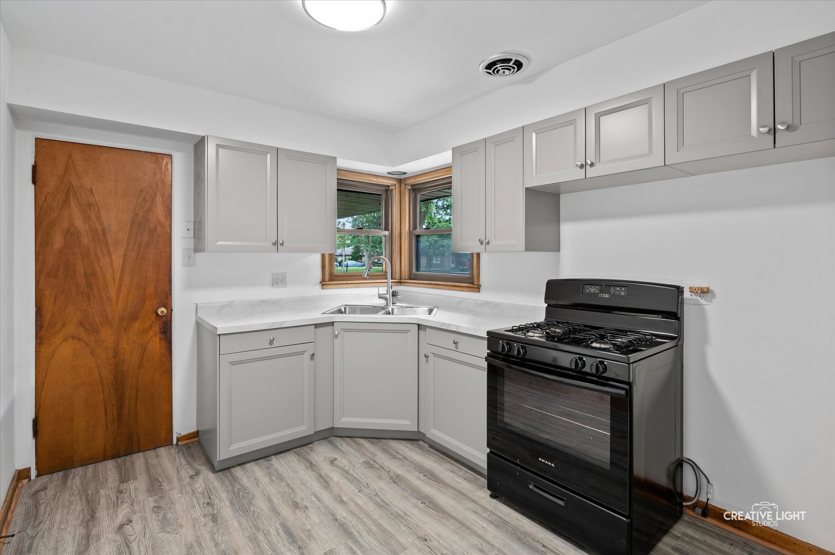 803 Alann Drive Joliet, IL 60435 - Photo 7 of 15 a kitchen with cabinets appliances and wooden floor