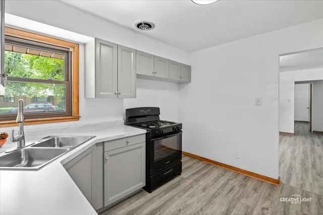 a kitchen with a stove and a sink