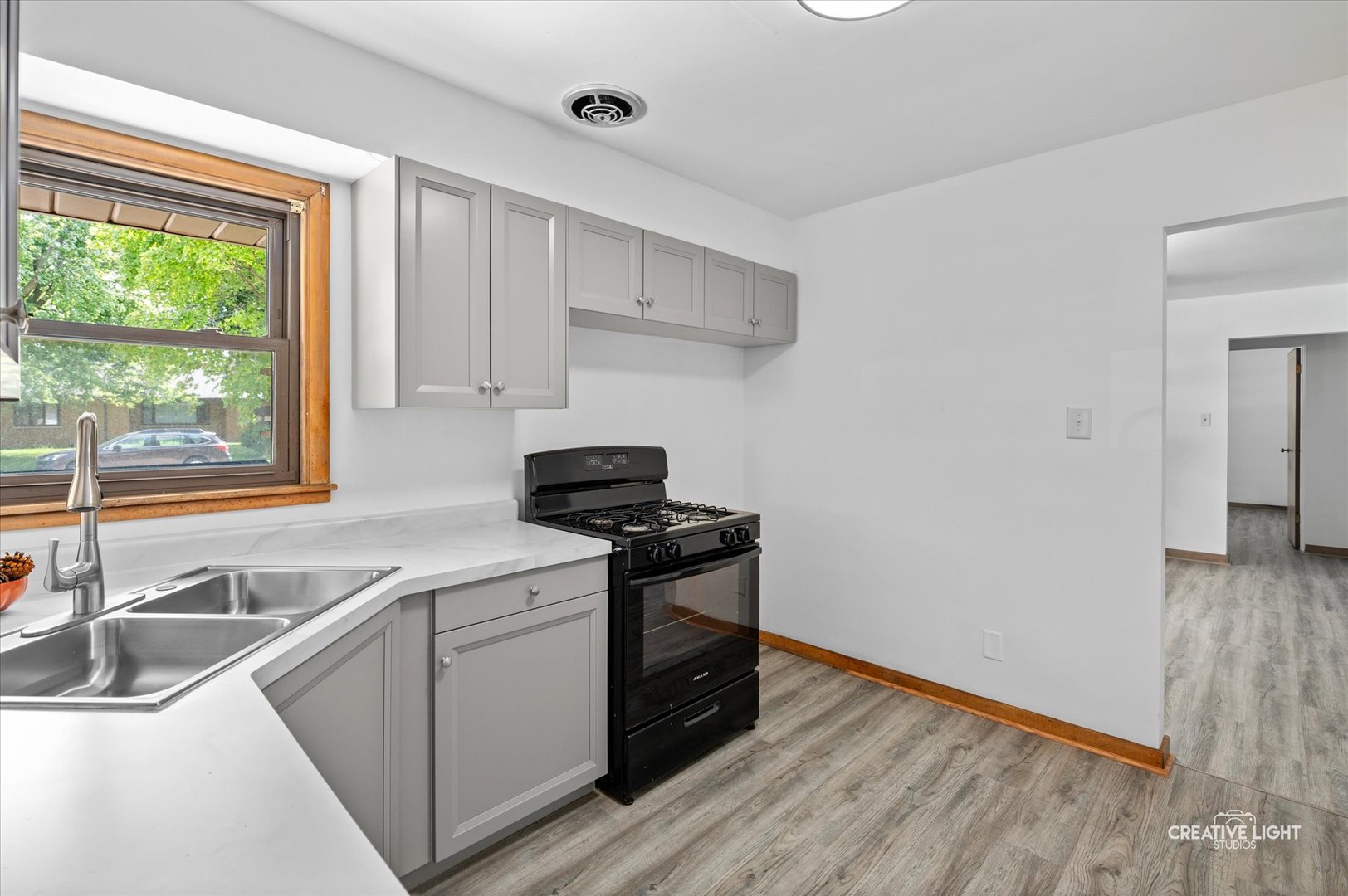 803 Alann Drive Joliet, IL 60435 - Photo 8 of 15 a kitchen with a stove and a sink