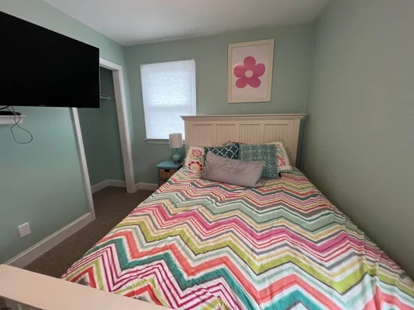 a bedroom with a bed and a television