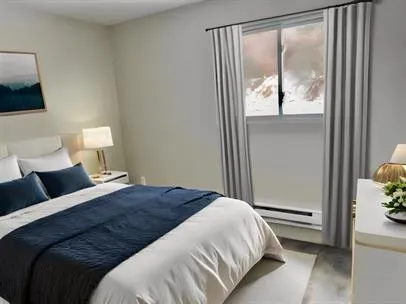 a bedroom with a bed and a window