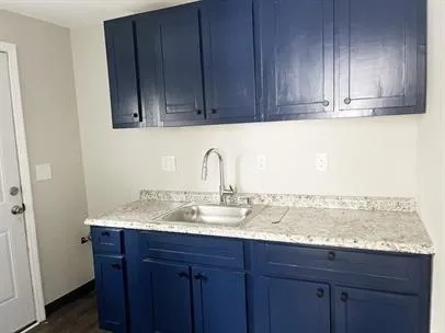 a sink with wooden cabinets