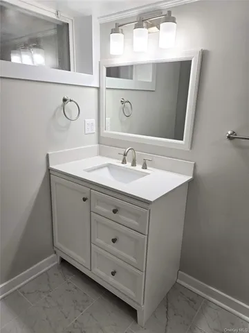 a bathroom with a sink vanity and mirror