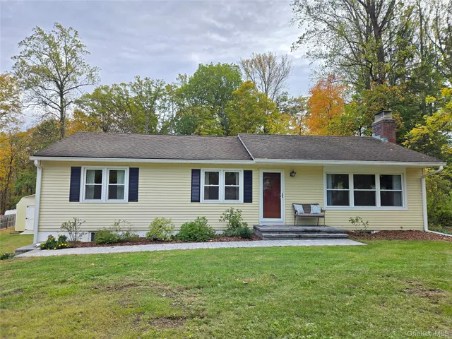 a front view of house with yard and green space