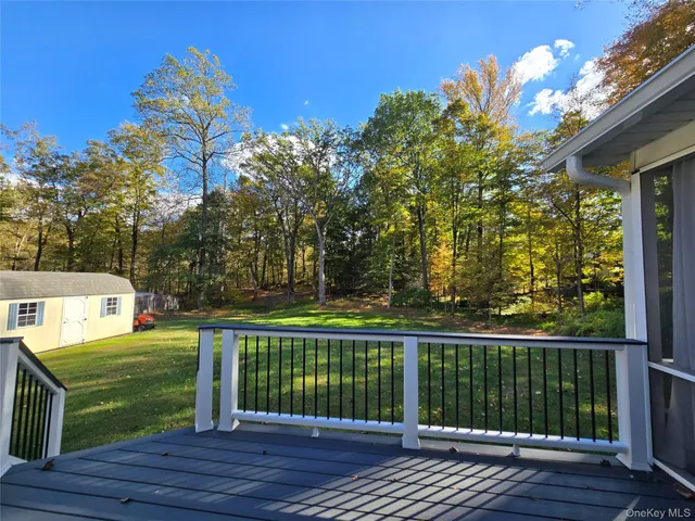 a view of a wooden deck and a yard