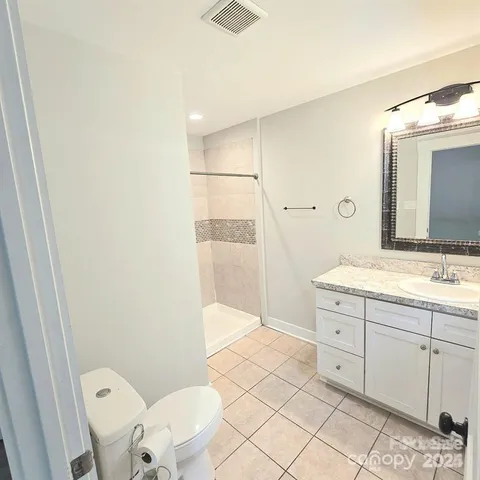 a bathroom with a sink a toilet and mirror