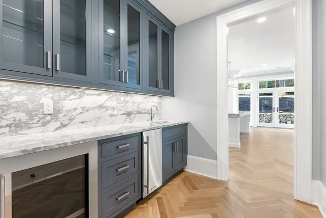 a bathroom with a granite countertop double vanity sink and mirror