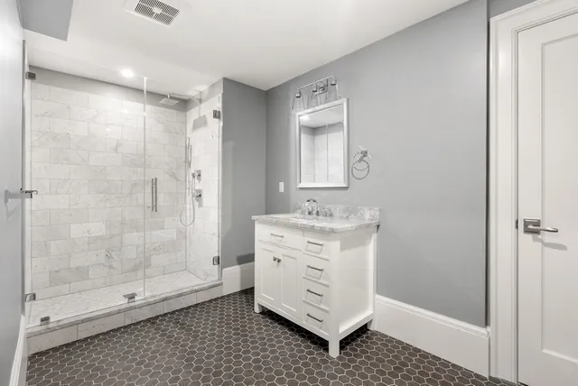 a bathroom with a shower toilet and sink