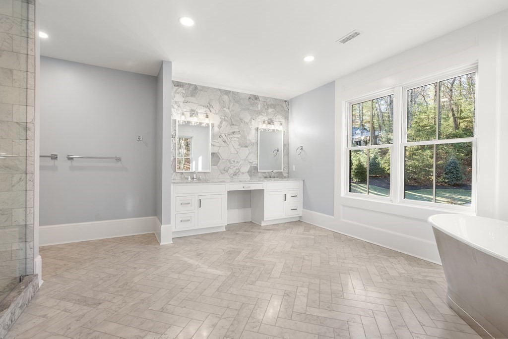 192 Pond Road Wellesley, MA 02482 - Photo 20 of 41 a large white tub sitting in a room next to a large window