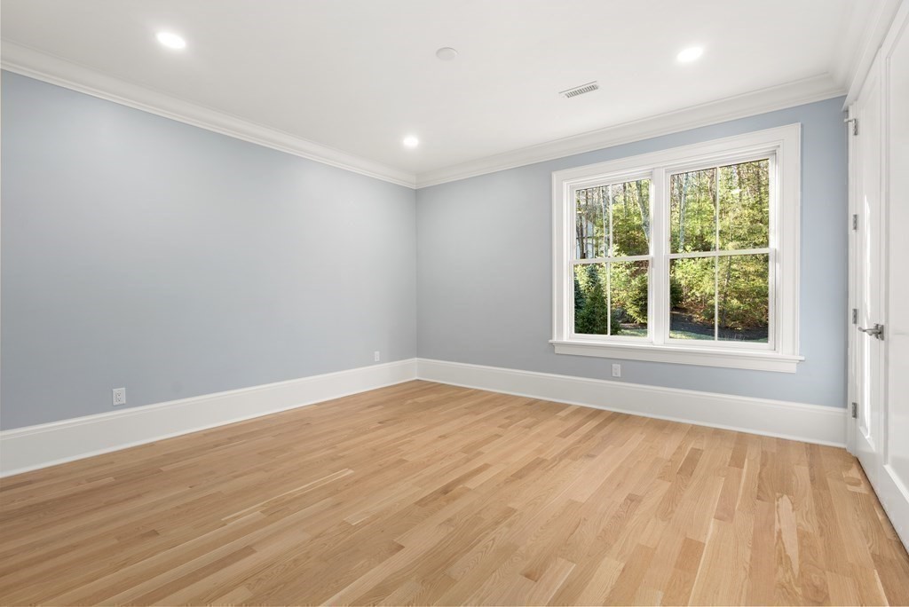 192 Pond Road Wellesley, MA 02482 - Photo 21 of 41 a view of an empty room with wooden floor and a window