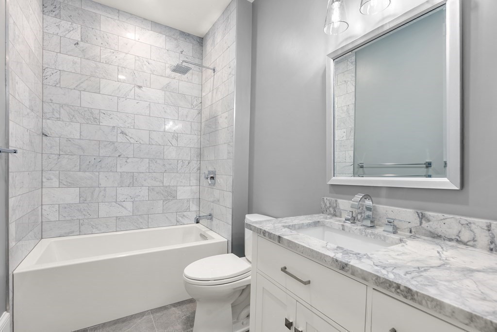 192 Pond Road Wellesley, MA 02482 - Photo 22 of 41 a bathroom with a granite countertop sink toilet mirror and bathtub