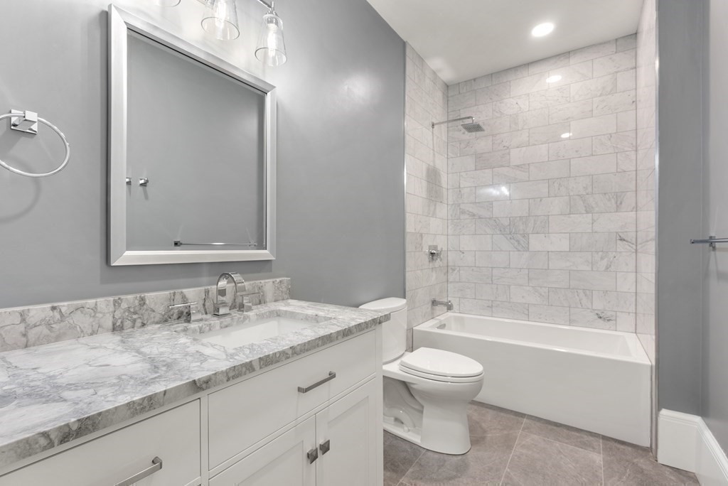 192 Pond Road Wellesley, MA 02482 - Photo 24 of 41 a bathroom with a granite countertop toilet a sink and a bathtub