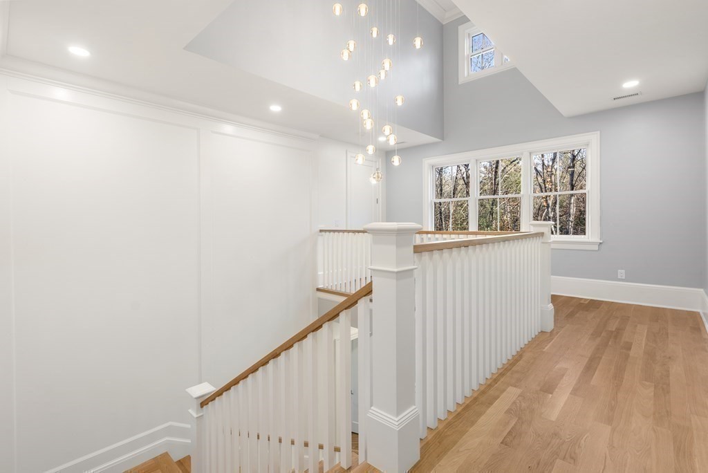 192 Pond Road Wellesley, MA 02482 - Photo 26 of 41 a view of a hallway with wooden floor and staircase