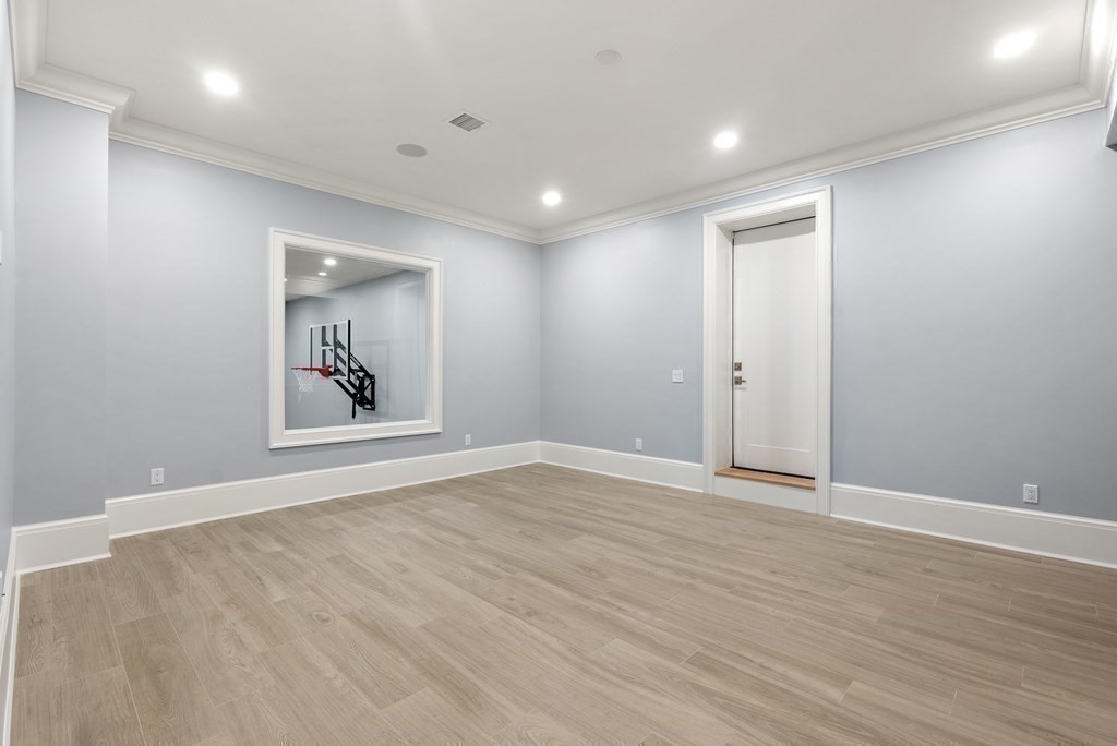 192 Pond Road Wellesley, MA 02482 - Photo 32 of 41 a view of an empty room with wooden floor and a window