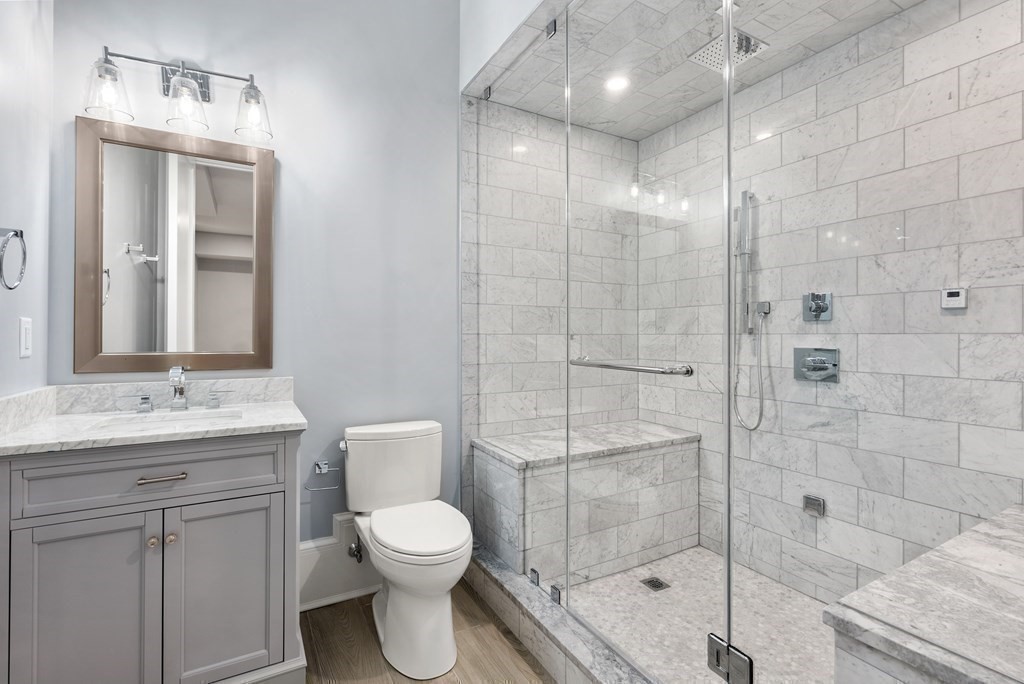 192 Pond Road Wellesley, MA 02482 - Photo 33 of 41 a bathroom with a toilet a sink a glass door shower and mirror