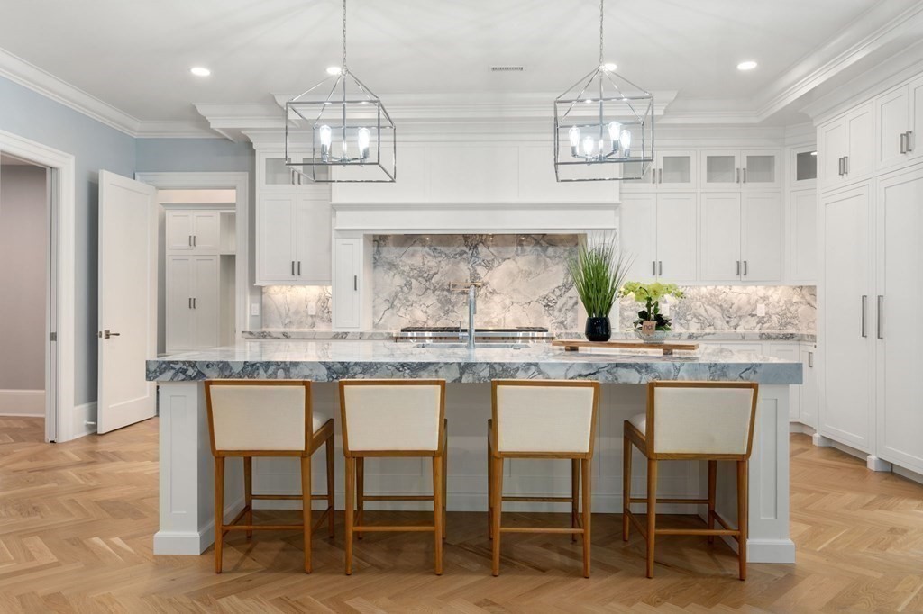 192 Pond Road Wellesley, MA 02482 - Photo 4 of 41 a kitchen with granite countertop white cabinets and chairs
