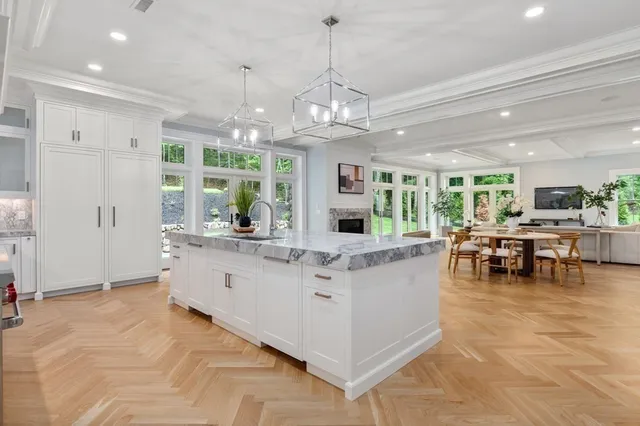 a view of living room with kitchen island granite countertop furniture and fireplace