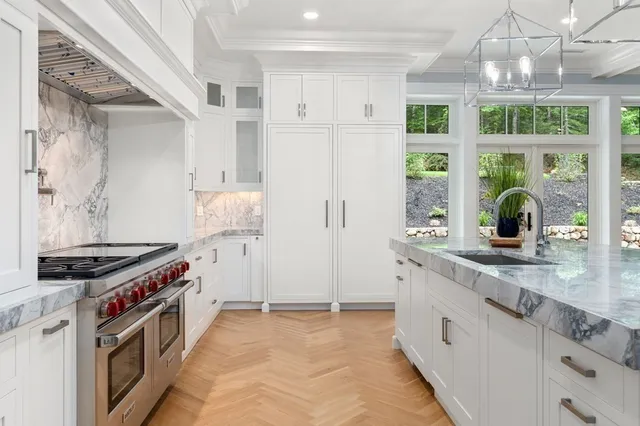 a kitchen with stainless steel appliances granite countertop a stove and a sink