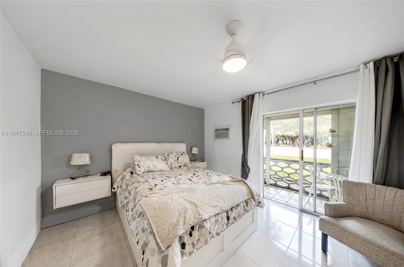 15610 Northeast 6th Avenue, Unit 9B Miami, FL 33162 - Photo 11 of 25 a bedroom with a bed and a couch