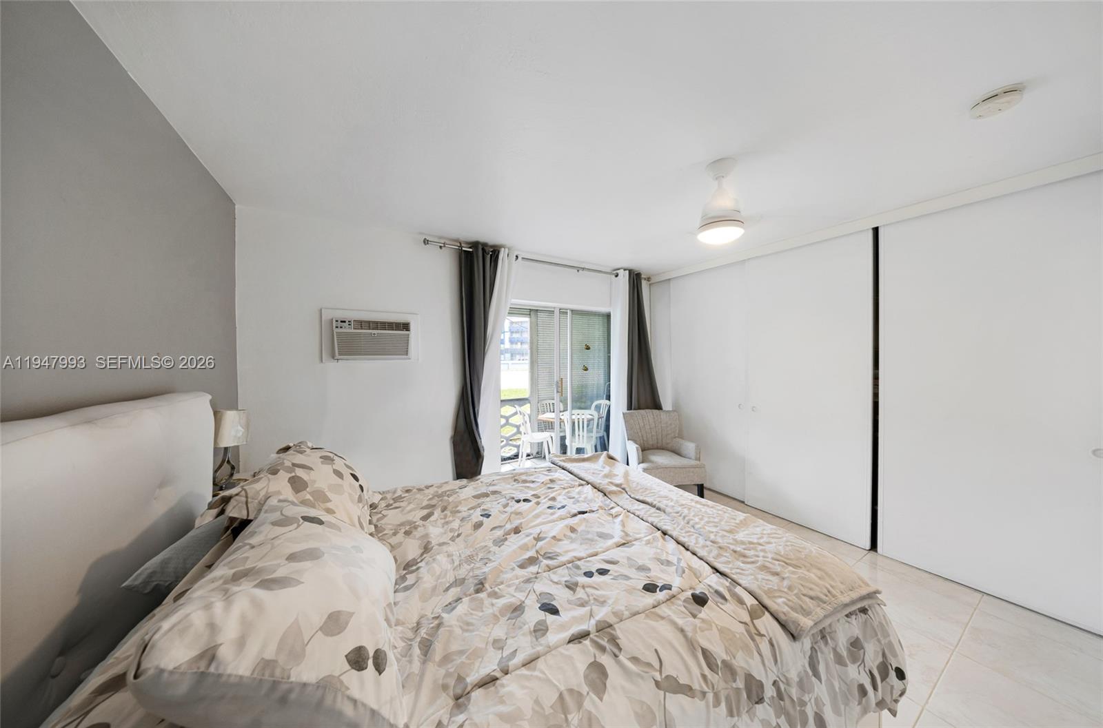 15610 Northeast 6th Avenue, Unit 9B Miami, FL 33162 - Photo 12 of 25 a bedroom with a bed and a window