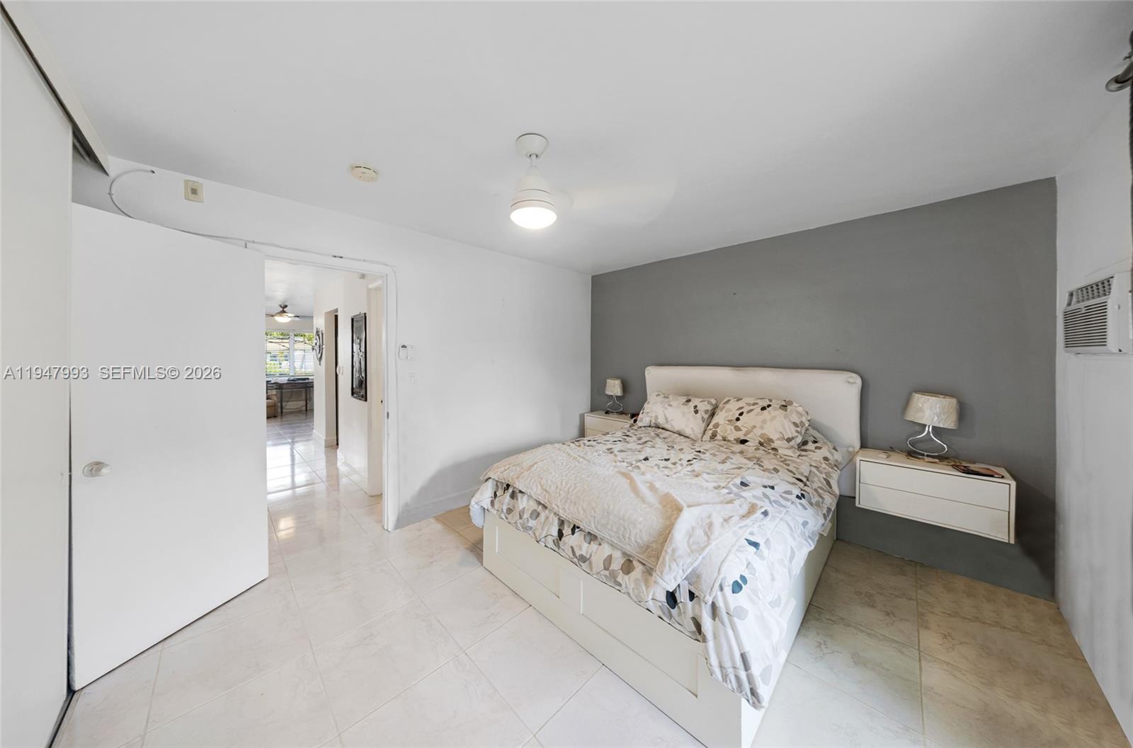 15610 Northeast 6th Avenue, Unit 9B Miami, FL 33162 - Photo 13 of 25 a bedroom with a bed and a walk in closet