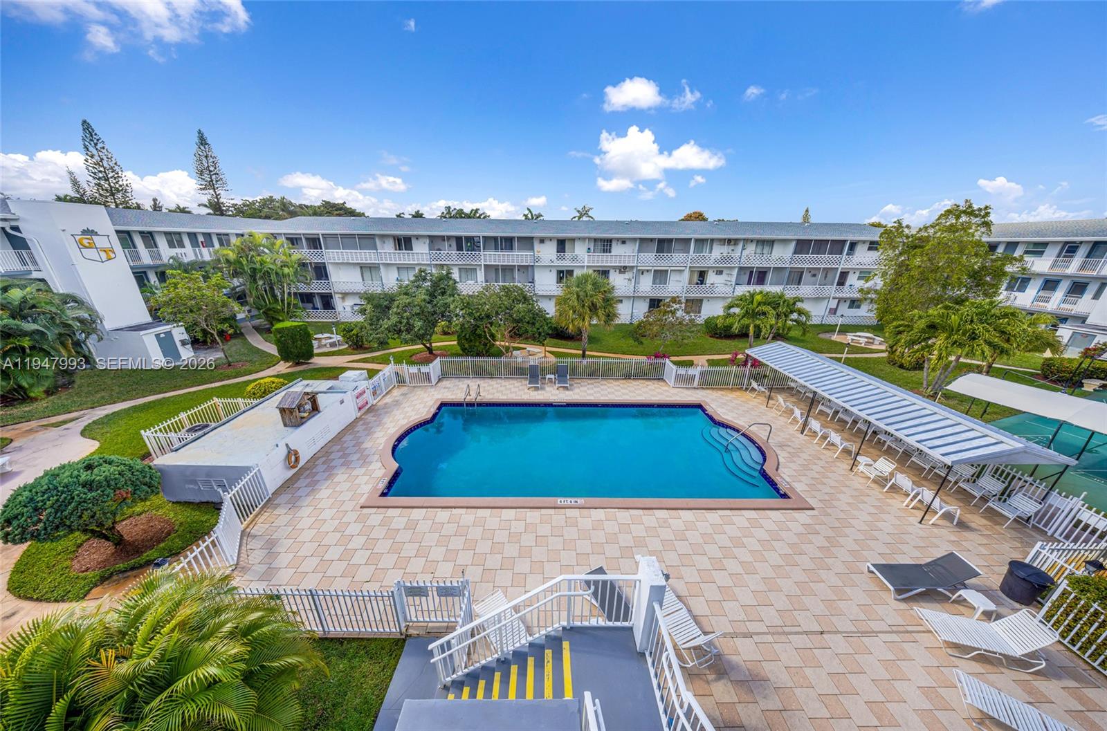 15610 Northeast 6th Avenue, Unit 9B Miami, FL 33162 - Photo 22 of 25 a view of a swimming pool and a yard