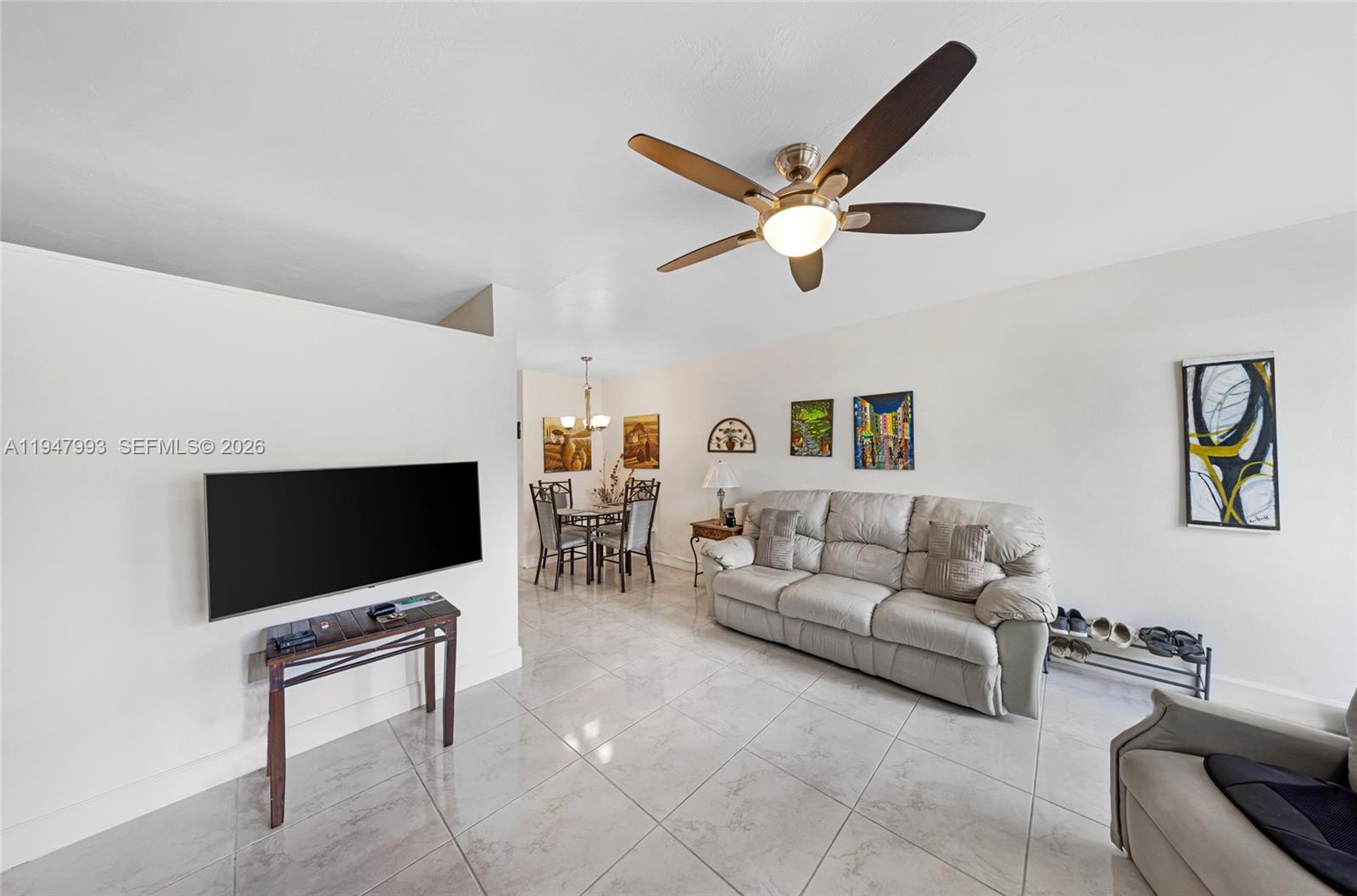 15610 Northeast 6th Avenue, Unit 9B Miami, FL 33162 - Photo 3 of 25 a living room with furniture and a flat screen tv