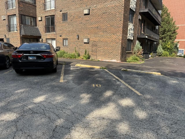 677 South River Road, Unit 2A Des Plaines, IL 60016 - Photo 15 of 15 a car parked in front of brick building