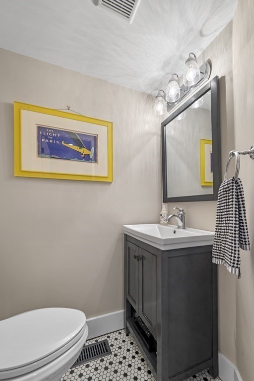 3 State Street Marblehead, MA 01945 - Photo 12 of 33 a bathroom with a toilet a sink and mirror