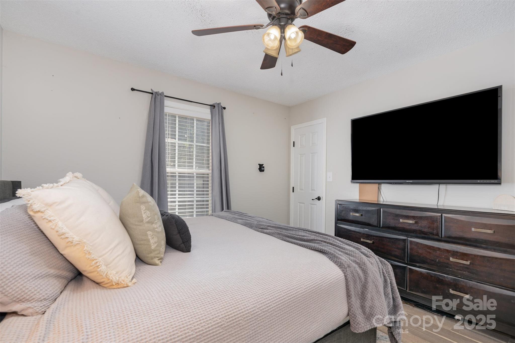 809 Fargo Drive Southwest Concord, NC 28027 - Photo 16 of 24 a bedroom with a bed and a flat screen tv