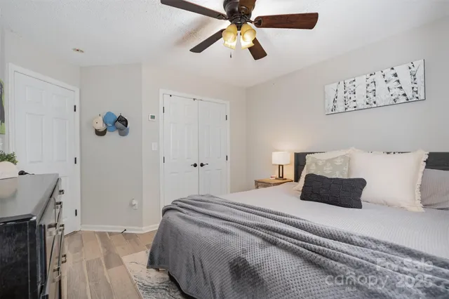a bedroom with a bed and a chandelier