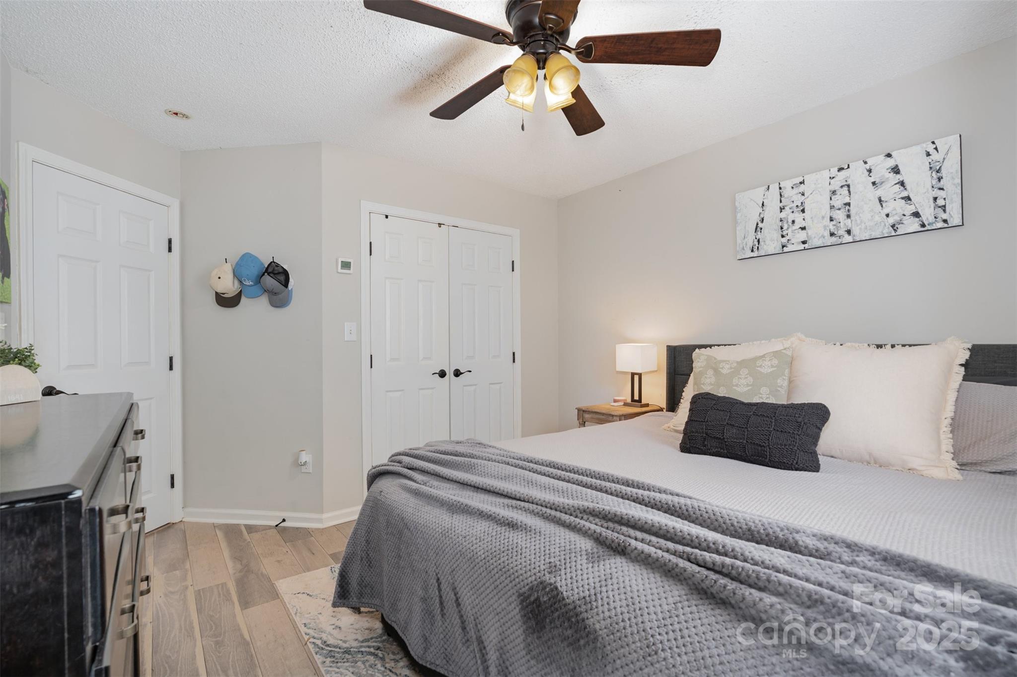 809 Fargo Drive Southwest Concord, NC 28027 - Photo 17 of 24 a bedroom with a bed and a chandelier
