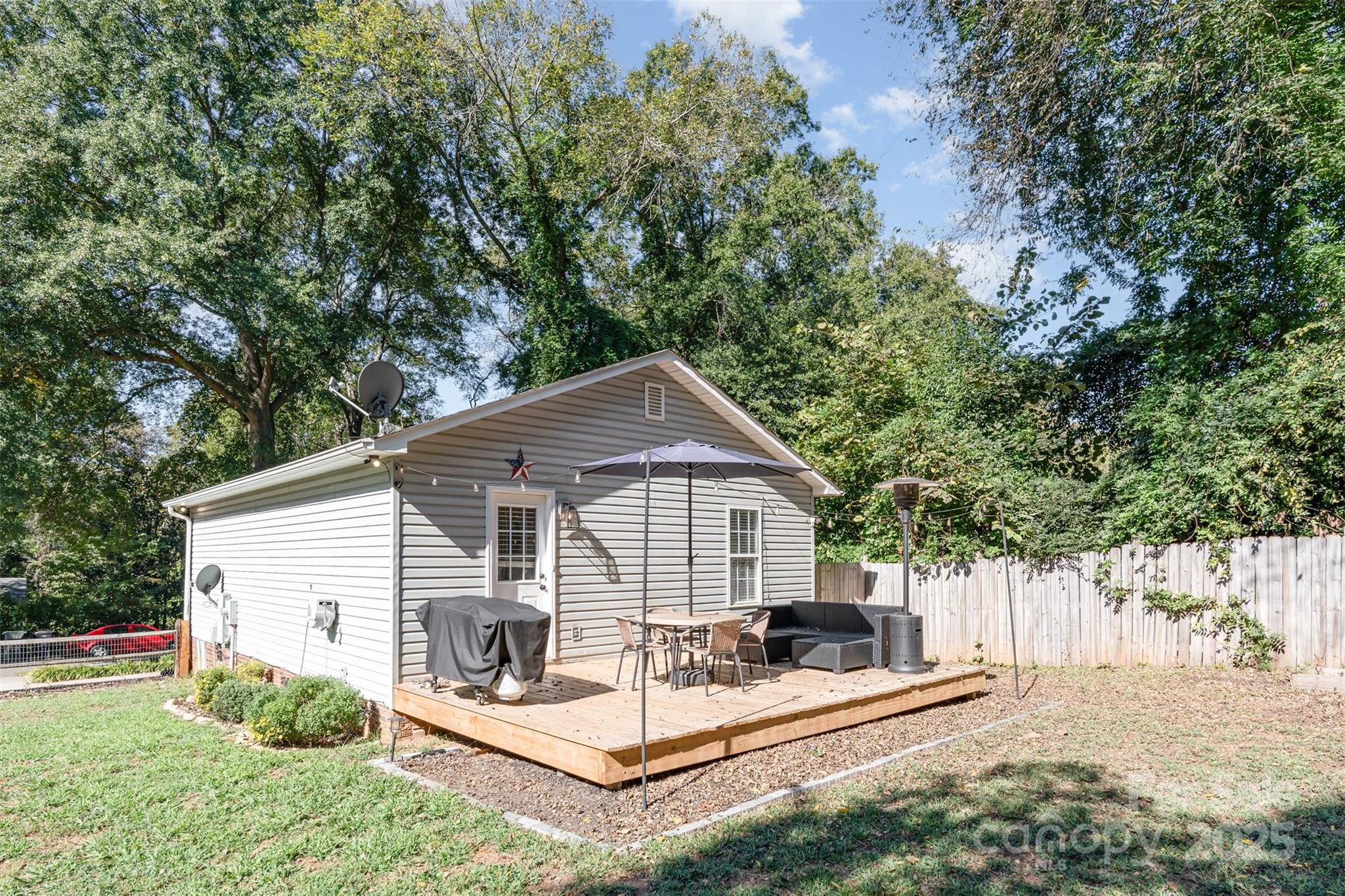 809 Fargo Drive Southwest Concord, NC 28027 - Photo 22 of 24 a view of a white house and a small yard with large trees