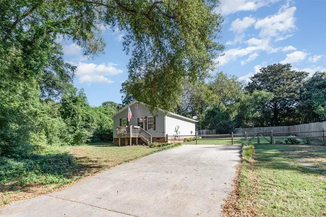 a view of a house with swimming pool and a yard