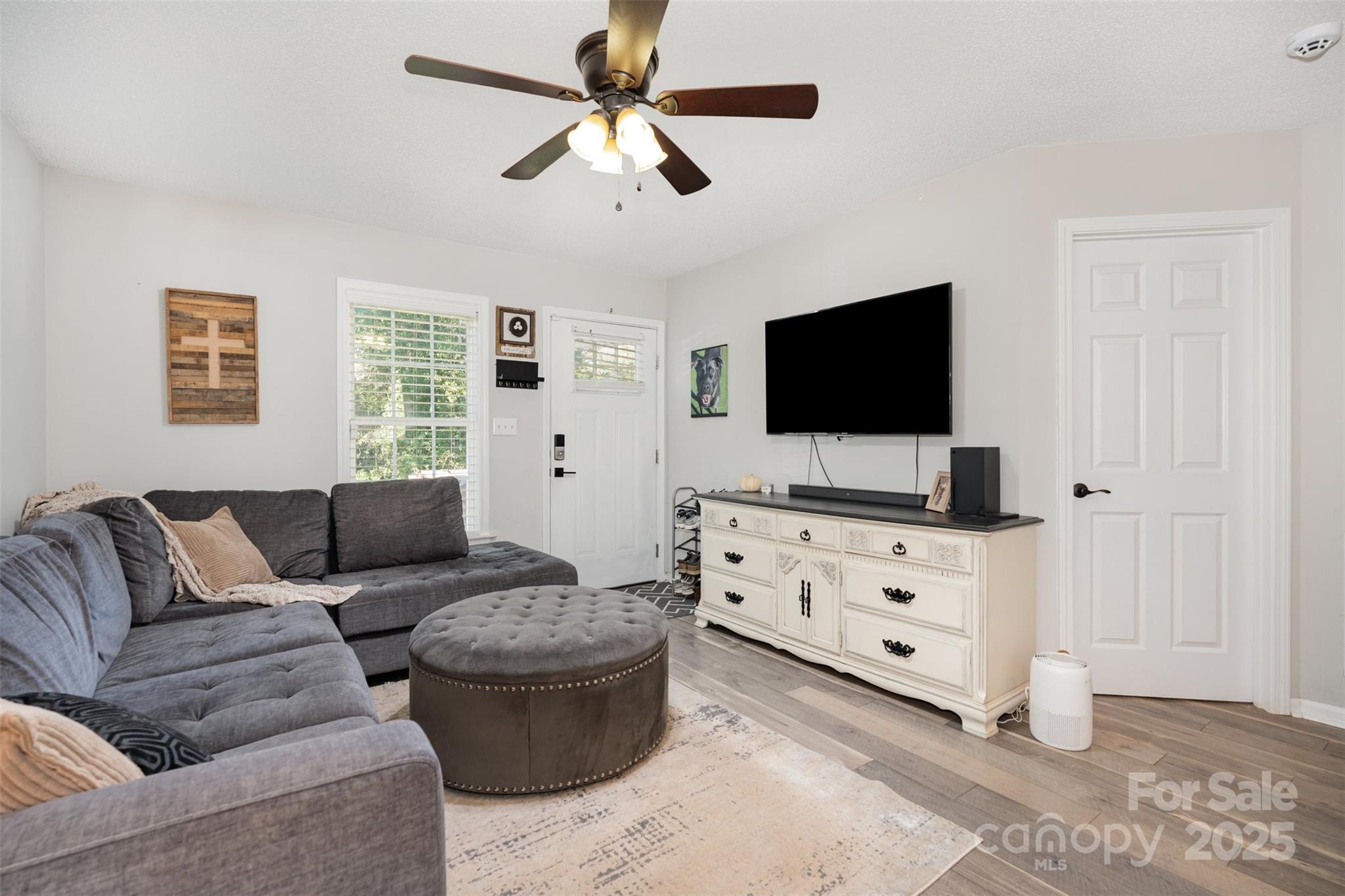 809 Fargo Drive Southwest Concord, NC 28027 - Photo 9 of 24 a living room with furniture and a flat screen tv