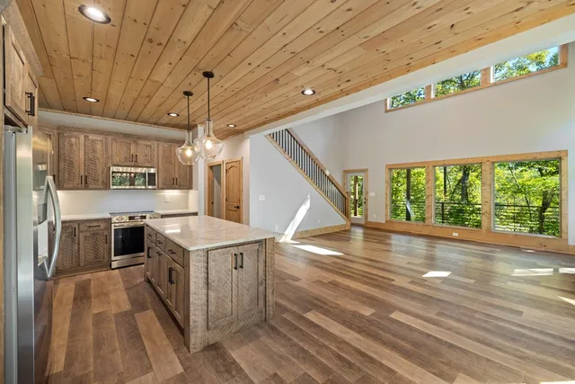 a open kitchen with a stove a sink and a refrigerator