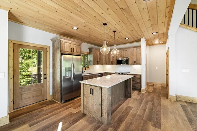 a kitchen with a stove a refrigerator and a sink