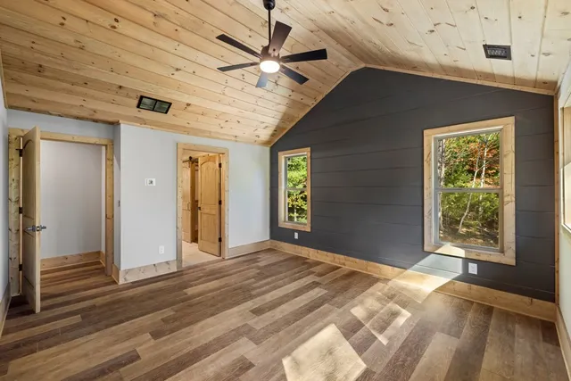 a view of a livingroom with a ceiling fan and window
