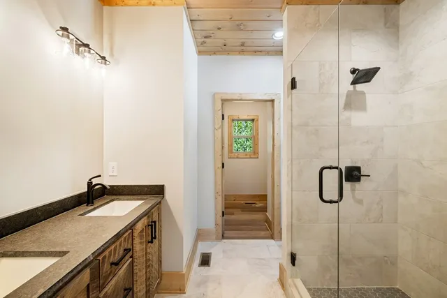 a bathroom with a granite countertop shower
