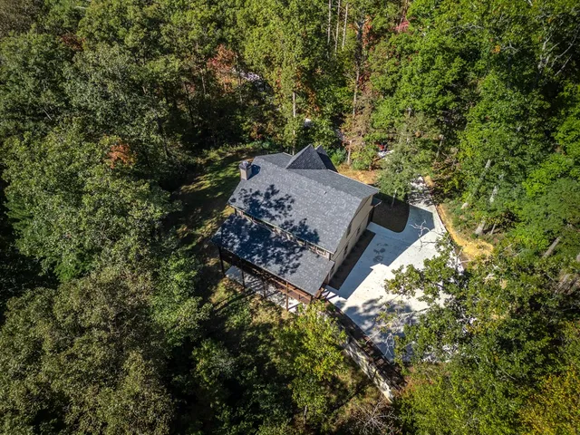 an aerial view of houses with trees