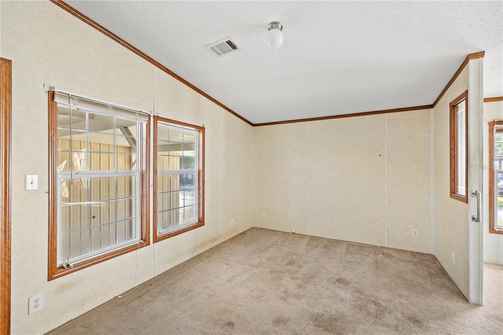 32443 Memory Lane Leesburg, FL 34788 - Photo 20 of 51 a view of an empty room with a window
