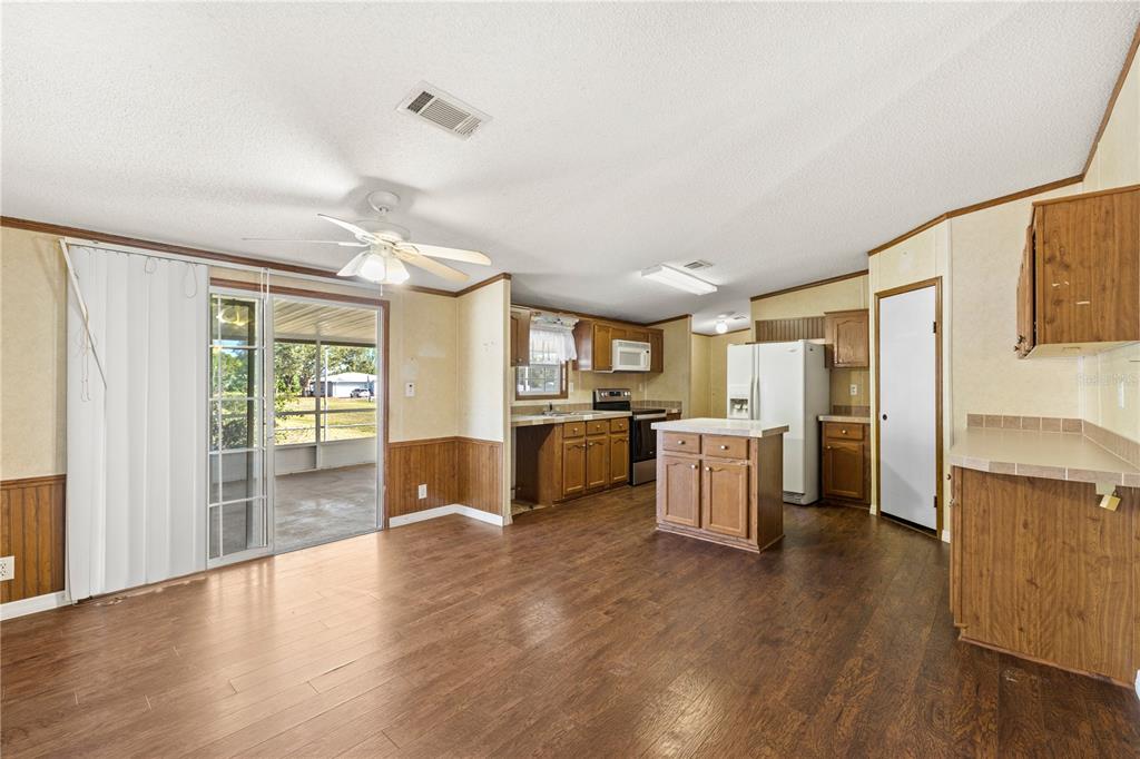 32443 Memory Lane Leesburg, FL 34788 - Photo 24 of 51 a kitchen with a sink cabinets stainless steel appliances and wooden floor