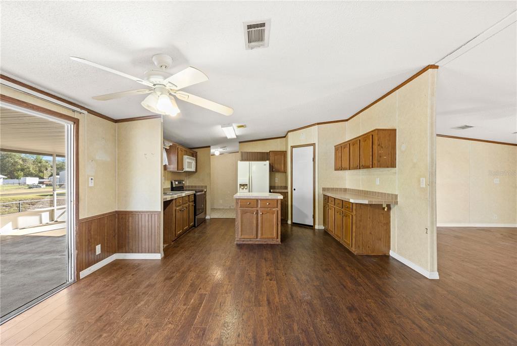 32443 Memory Lane Leesburg, FL 34788 - Photo 25 of 51 a view of a kitchen with furniture and wooden floor