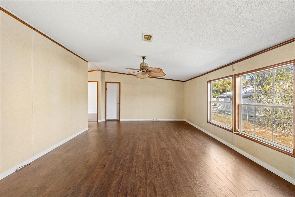 32443 Memory Lane Leesburg, FL 34788 - Photo 30 of 51 wooden floor in an empty room with a window