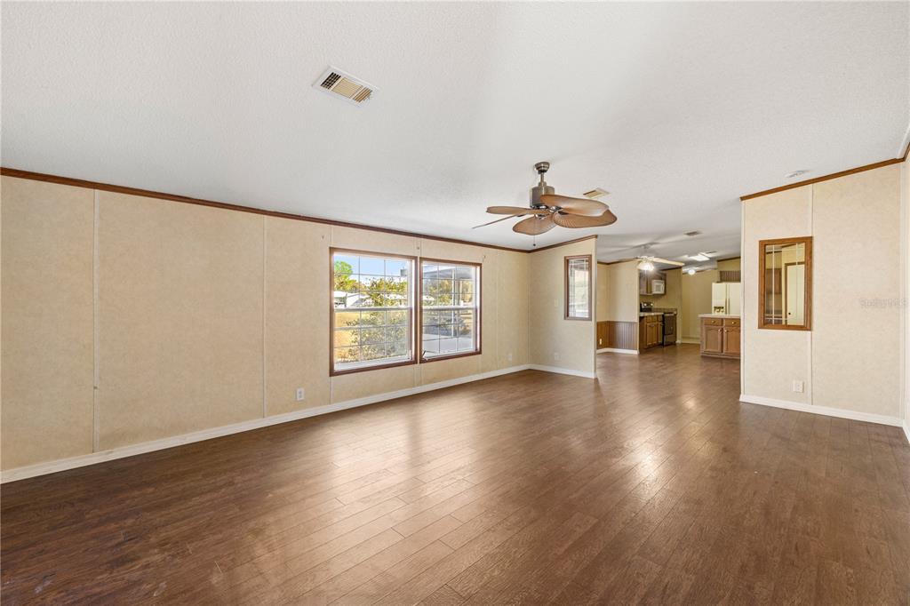 32443 Memory Lane Leesburg, FL 34788 - Photo 33 of 51 a view of an empty room with wooden floor and a window