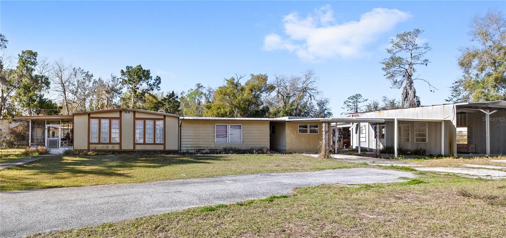 32443 Memory Lane Leesburg, FL 34788 - Photo 4 of 51 a front view of a house with a yard